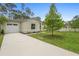 Well-kept home featuring a driveway, a manicured lawn, and a cozy, fenced neighbor's yard at 1683 10Th Ave, Deland, FL 32724