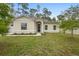 Charming single-story home featuring a well-manicured lawn and a welcoming front entrance and a two-car garage at 1683 10Th Ave, Deland, FL 32724