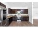 Modern kitchen featuring stainless steel appliances, dark wood cabinetry, and granite countertops at 1683 10Th Ave, Deland, FL 32724