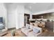 Open-concept living space with kitchen featuring stainless steel appliances, dining area, and cozy seating at 1683 10Th Ave, Deland, FL 32724