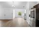 View of open living space, kitchen with stainless steel appliances, and adjacent open space with window at 1683 10Th Ave, Deland, FL 32724