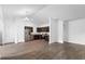 Open living space showcasing laminate floors, modern kitchen with stainless appliances and white walls at 1683 10Th Ave, Deland, FL 32724