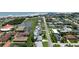 Aerial view of a residential street with single-Gathering homes, some with pools, near a beach and coastal waters at 179 Ann Rustin S Dr, Ormond Beach, FL 32176