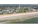 Beautiful aerial view of sandy beach, coastal hotel with a pool, and oceanfront community in a coastal city at 179 Ann Rustin S Dr, Ormond Beach, FL 32176
