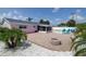 Backyard showcasing pool, patio, and home exterior with palm trees at 179 Ann Rustin S Dr, Ormond Beach, FL 32176