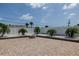 Paver patio with a fire pit surrounded by palm trees and white gravel at 179 Ann Rustin S Dr, Ormond Beach, FL 32176
