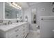 Elegant bathroom featuring a double vanity with marble countertop and modern fixtures at 179 Ann Rustin S Dr, Ormond Beach, FL 32176