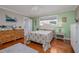 Well-lit bedroom showcasing hardwood floors, a cozy bed, and bright, airy decor at 179 Ann Rustin S Dr, Ormond Beach, FL 32176