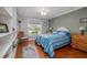 Cozy bedroom with wood floors, built-in shelving, and a bright window view at 179 Ann Rustin S Dr, Ormond Beach, FL 32176