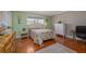 Comfortable bedroom with hardwood floors, featuring a cozy bed and ample natural light at 179 Ann Rustin S Dr, Ormond Beach, FL 32176