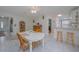 Comfortable dining space showcasing tile flooring, a white table, and views into the adjacent kitchen at 179 Ann Rustin S Dr, Ormond Beach, FL 32176