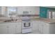 Well-lit kitchen showcases white cabinets, modern appliances, and a window offering natural light at 179 Ann Rustin S Dr, Ormond Beach, FL 32176