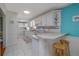 Clean kitchen featuring white cabinetry, a breakfast bar, and ample counter space for cooking and entertaining at 179 Ann Rustin S Dr, Ormond Beach, FL 32176