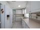 Bright kitchen featuring white cabinets, appliances, and tiled flooring, with modern design and decor at 179 Ann Rustin S Dr, Ormond Beach, FL 32176