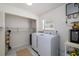 Efficient laundry room equipped with a modern washer and dryer, and ample storage space at 179 Ann Rustin S Dr, Ormond Beach, FL 32176