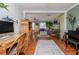 View of the living area highlighting the hardwood floors, rattan shelving, and seamless transition to the next room at 179 Ann Rustin S Dr, Ormond Beach, FL 32176