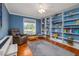 Inviting living room with hardwood floors, a comfortable recliner, and custom built-in shelving at 179 Ann Rustin S Dr, Ormond Beach, FL 32176