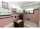 Classic pink bathroom with tile, featuring a vanity and updated lighting at 18 S Shell Rd, Debary, FL 32713