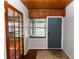 Foyer featuring a wooden ceiling, beautiful flooring, wood-trimmed glass doors, and access to additional rooms at 18 S Shell Rd, Debary, FL 32713