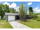 Charming one-story home with a well-maintained lawn, mature bamboo, and attached garage with a private fenced entrance at 18 S Shell Rd, Debary, FL 32713