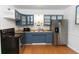 Renovated kitchen with stainless steel appliances, stylish blue cabinets, and butcher block countertops at 18 S Shell Rd, Debary, FL 32713