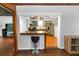 View from living area looking into kitchen; showcases a bar area, stainless appliances, stylish blue cabinets, and butcher block counters at 18 S Shell Rd, Debary, FL 32713
