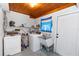 Laundry room with washer, dryer, utility sink, and storage space, providing convenience and functionality at 18 S Shell Rd, Debary, FL 32713