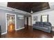 Cozy living room with hardwood floors, gray walls, modern ceiling, and a view into the kitchen and other rooms at 18 S Shell Rd, Debary, FL 32713