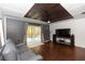 Living room features wooden ceiling, modern decor, gray walls, hardwood floors and sliding doors leading to the outside at 18 S Shell Rd, Debary, FL 32713