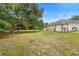 Sprawling backyard with lush greenery, large trees, and a glimpse of the house at 185 Brookside Dr, Port Orange, FL 32128