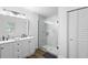 Modern bathroom featuring a glass shower, double vanity and white cabinets at 185 Brookside Dr, Port Orange, FL 32128