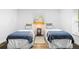 Inviting bedroom featuring twin beds, wood-look floors, soft lighting and a window at 185 Brookside Dr, Port Orange, FL 32128
