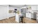 Stylish kitchen with white cabinets, stainless steel appliances, and breakfast island at 185 Brookside Dr, Port Orange, FL 32128