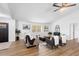 Bright living room featuring wood floors, neutral furniture, and a large window offering plenty of natural light at 185 Brookside Dr, Port Orange, FL 32128