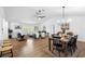 Open-concept living and dining area with modern lighting, stylish furniture, and wood flooring throughout at 185 Brookside Dr, Port Orange, FL 32128