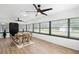 Bright sunroom featuring a dining table, lots of windows, and hardwood-look flooring at 185 Brookside Dr, Port Orange, FL 32128