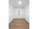 Spacious walk-in closet with wood-look flooring, white walls and baseboards, and adjustable white wire shelving at 185 Brookside Dr, Port Orange, FL 32128