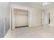 Bright bedroom featuring tile floors, ceiling fan, and a closet with bi-fold doors and built-in shelving at 1935 Conway Rd # A4, Orlando, FL 32812