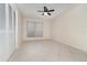 Bright bedroom with tile flooring, large window, and closet with folding doors at 1935 Conway Rd # A4, Orlando, FL 32812