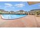 Large community pool surrounded by lounge chairs and lush landscaping at 1935 Conway Rd # A4, Orlando, FL 32812