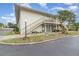 Two-story condo with a well-maintained lawn and landscaping in front of the stairway and porch at 1935 Conway Rd # A4, Orlando, FL 32812