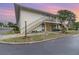 Two-story condo with a well-maintained lawn and landscaping in front of the stairway and porch at 1935 Conway Rd # A4, Orlando, FL 32812