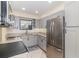 Bright kitchen features stainless steel appliances, granite countertops, gray cabinets, and a modern backsplash at 1935 Conway Rd # A4, Orlando, FL 32812