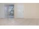 Bright living room features tile flooring, vertical blinds, and a door leading to the outside area at 1935 Conway Rd # A4, Orlando, FL 32812