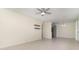 Open living space with tile floors, neutral paint, and a view into the kitchen with stainless appliances at 1935 Conway Rd # A4, Orlando, FL 32812