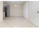 Open living space with tile floors, neutral paint, and a view into the kitchen with stainless appliances at 1935 Conway Rd # A4, Orlando, FL 32812