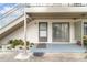This is the porch with a decorative mat, potted plants and rocks with plants near the stairway at 1935 Conway Rd # A4, Orlando, FL 32812