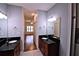 Bathroom featuring granite countertops, dual sinks, wood cabinets, and tile floors at 201 Walter Stevens Way, Deland, FL 32724