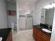 Bathroom with granite countertops, wood cabinets, tiled shower and floors at 201 Walter Stevens Way, Deland, FL 32724