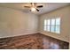 Bedroom features wood floors, bright window with shutters, and a ceiling fan at 201 Walter Stevens Way, Deland, FL 32724